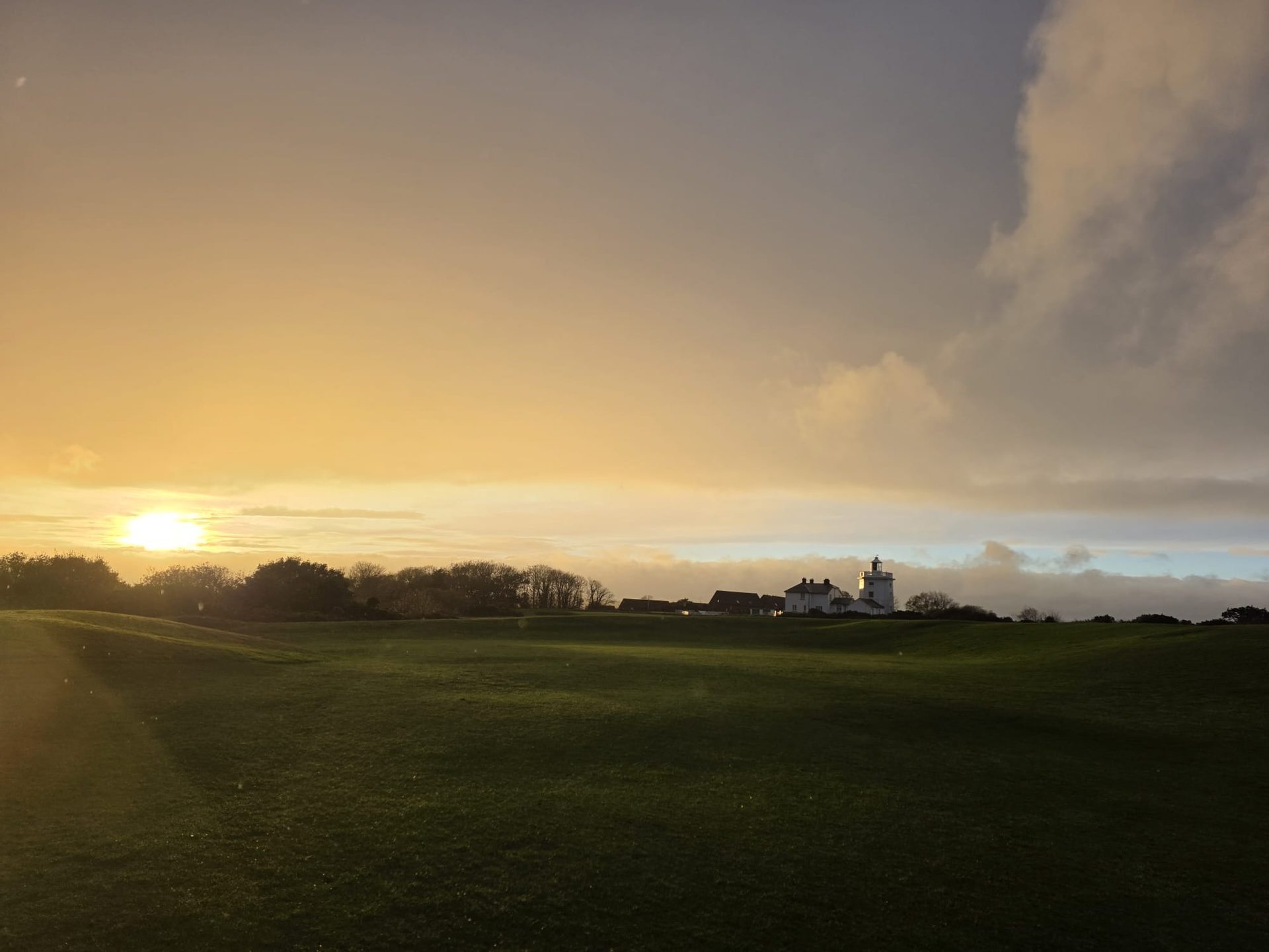 Royal Cromer — golfers in golden misty light