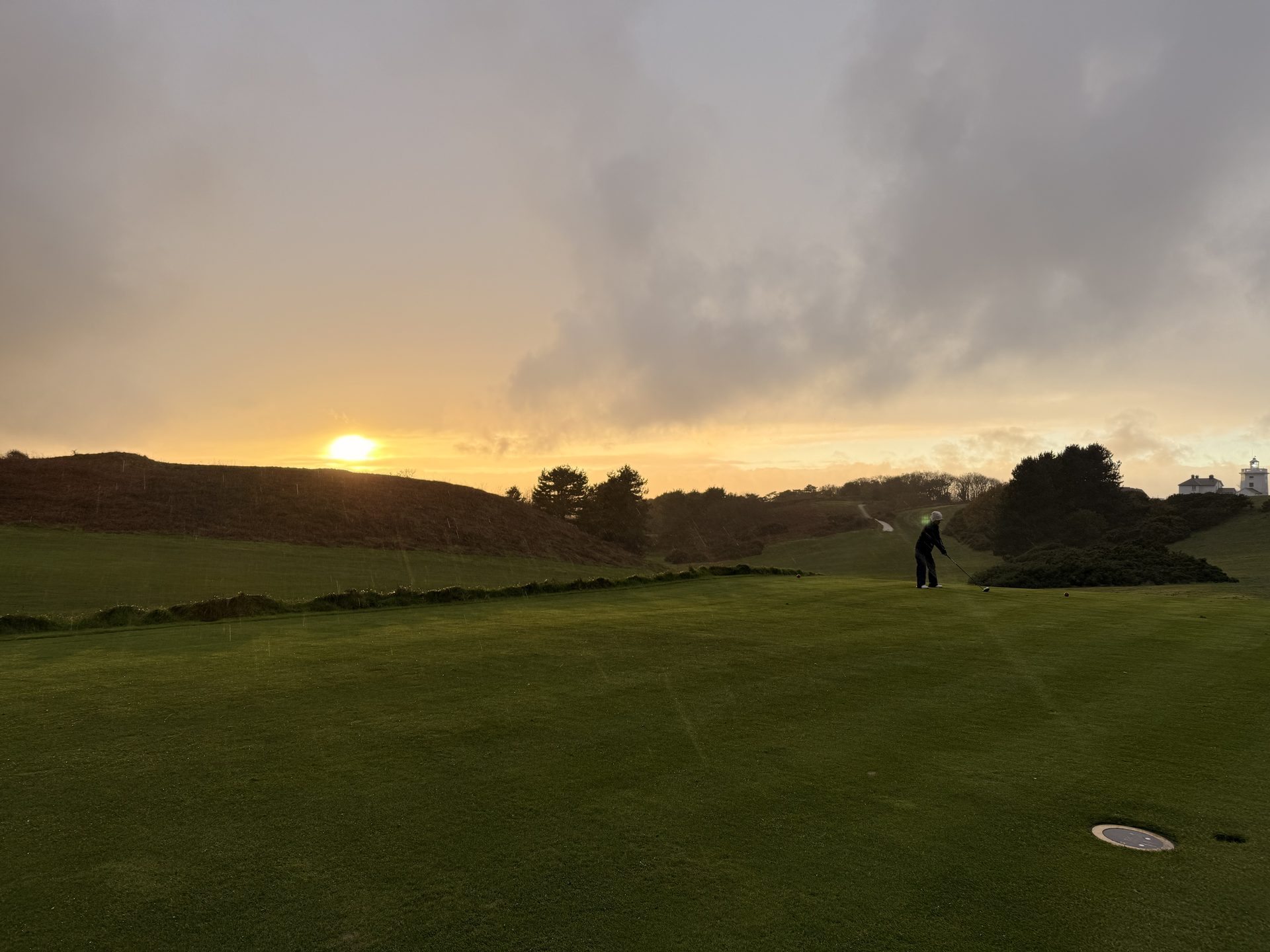 Royal Cromer — golfer putting at sunset